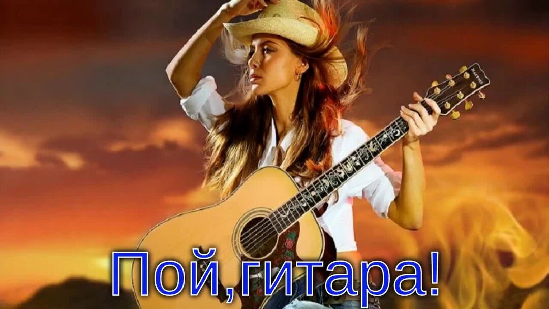 Девушка с гитарой поет песню на склоне горы.