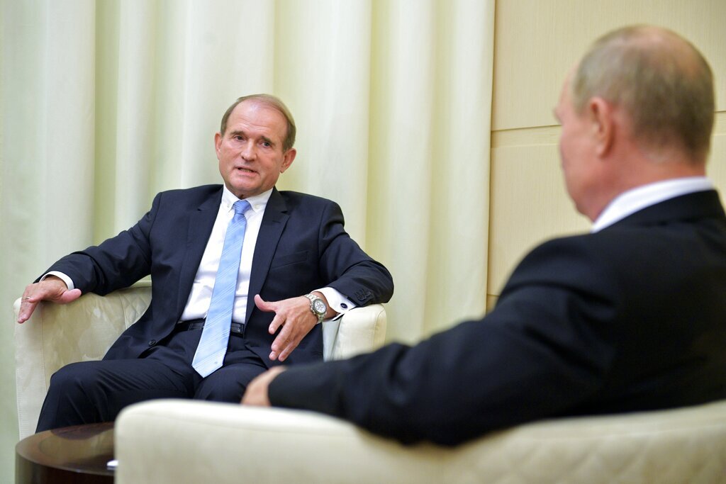    FILE - Ukrainian tycoon Viktor Medvedchuk, left, speaks to Russian President Vladimir Putin during a meeting at the Novo-Ogaryovo residence outside Moscow, Russia, Oct. 6, 2020. The detention on Tuesday, April 12, 2022 of fugitive Ukrainian oligarch Viktor Medvedchuk, who is both the former leader of a pro-Russian opposition party and a close associate of Russian leader Vladimir Putin, was met with enthusiasm in Kyiv — and irritation in Moscow. (Sputnik, Kremlin Pool Photo via AP, file) editor