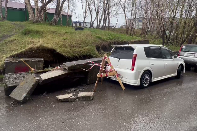   Часть упавшей подпорной стены повледила автомобили. Фото: масс медиа