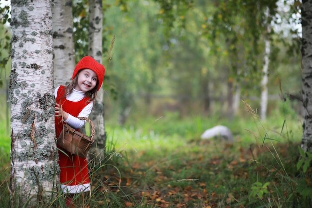 https://img.freepik.com/premium-photo/a-little-girl-in-a-red-hat-and-dresses-is-walking-in-the-park-cosplay-for-the-fairytale-hero-little-red-riding-hood_494741-34639.jpg