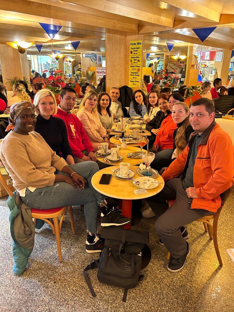 Немецкое кафе с группой на кофе с десертом.