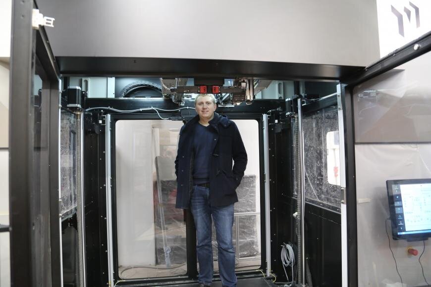 Сотрубник фирмы 3D.ru внутри принтера Massivit 1800