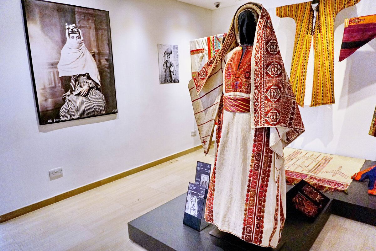 Амман, Музей арабского платья (в галерее платье крупным планом). Вышивка по белой ткани - отличительная черта платьев из Рамаллаха