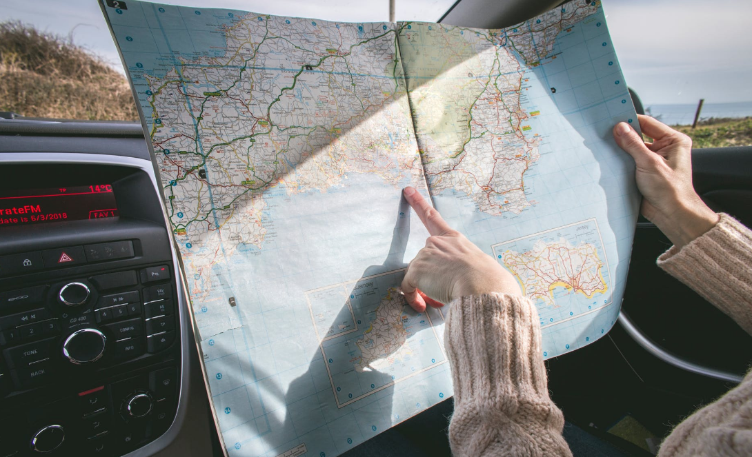 https://www.pexels.com/photo/person-wearing-beige-sweater-holding-map-inside-vehicle-1252500/