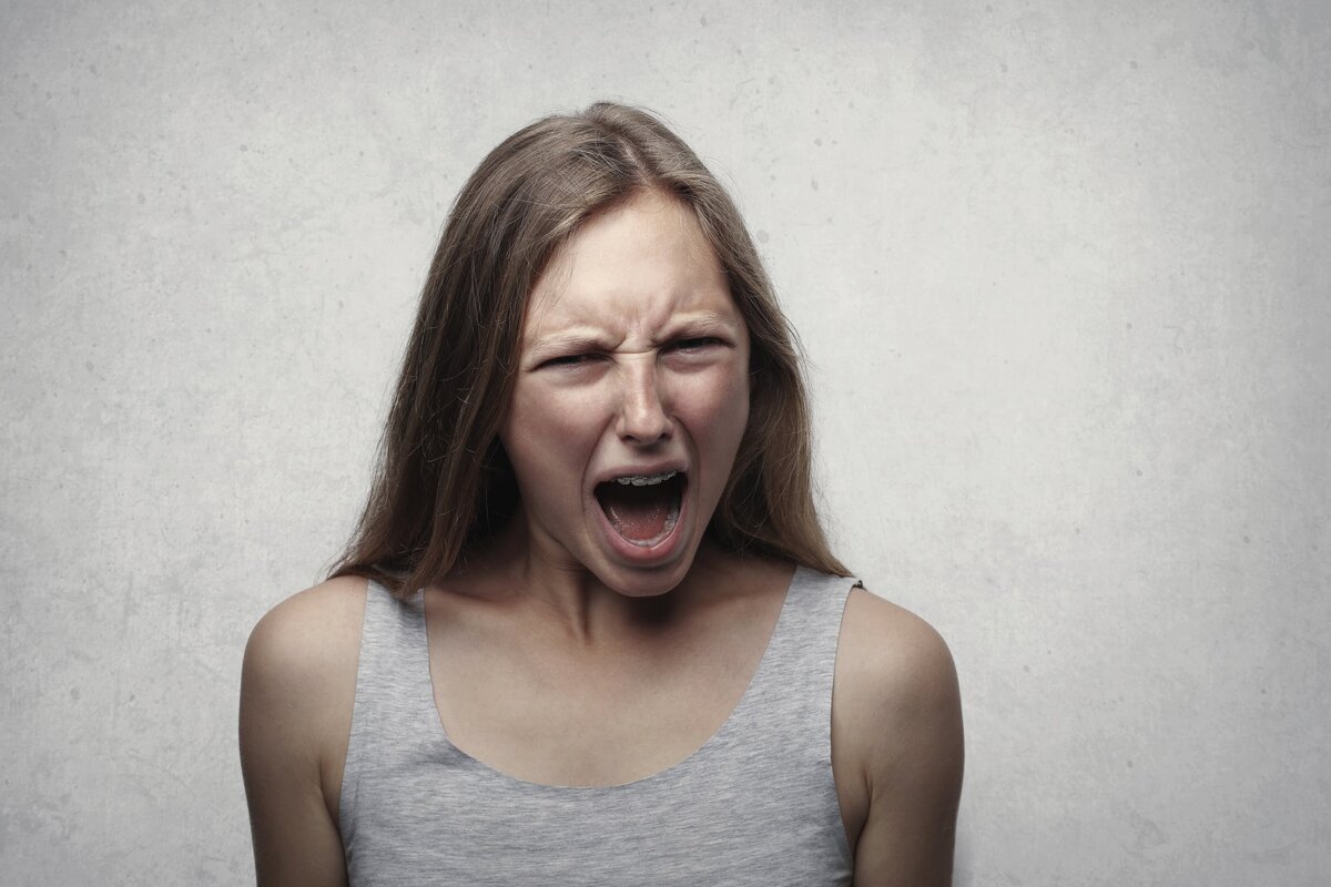 https://www.pexels.com/photo/woman-in-gray-tank-top-shouting-3812761/