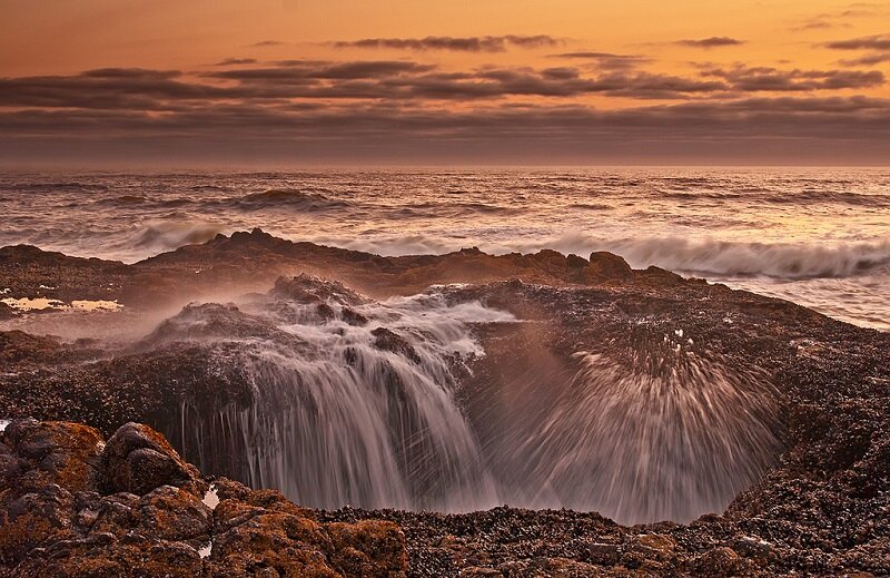 Когда мы отправляемся на отдых в туристическую поездку, как правило, главной целью становится желание увидеть как можно больше нового, интересного и запоминающегося – того, о чем можно было бы с упоением и восхищением рассказывать близким и друзьям. Одно из таких мест - это Колодец Тора или Thor’sWell, впрочем, как только его не называют - это и Бьющий Рог (theSpoutingHorn) и Дьявольский Колодец. Это величественное творение природы находится в штате Орегон, на мысе Перпетуа, славящемся на весь мир своими красивейшими закатами. 