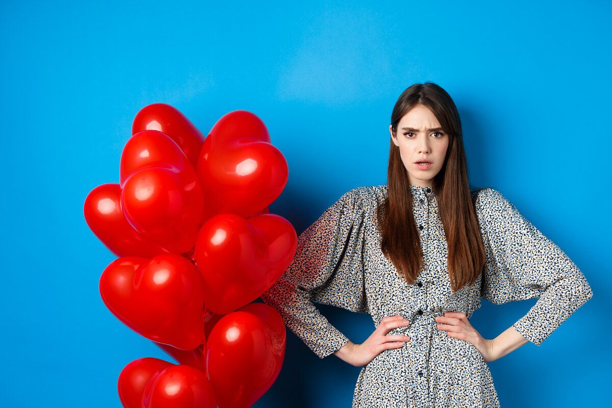 Photo by Look Studio on Unsplash/ https://unsplash.com/photos/a-woman-standing-next-to-a-bunch-of-red-balloons-katVwDJ9xI0