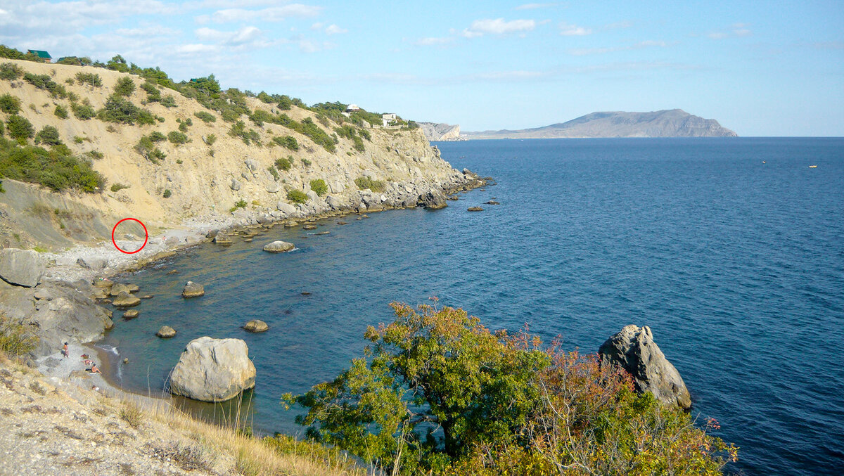 На переднем плане нудистский пляж. У большого камня. Небольшой, с галькой мелкого и среднего размера. А вот в том месте, которое я обвёл красным кружком, та самая труба, из которой "что-то течет".