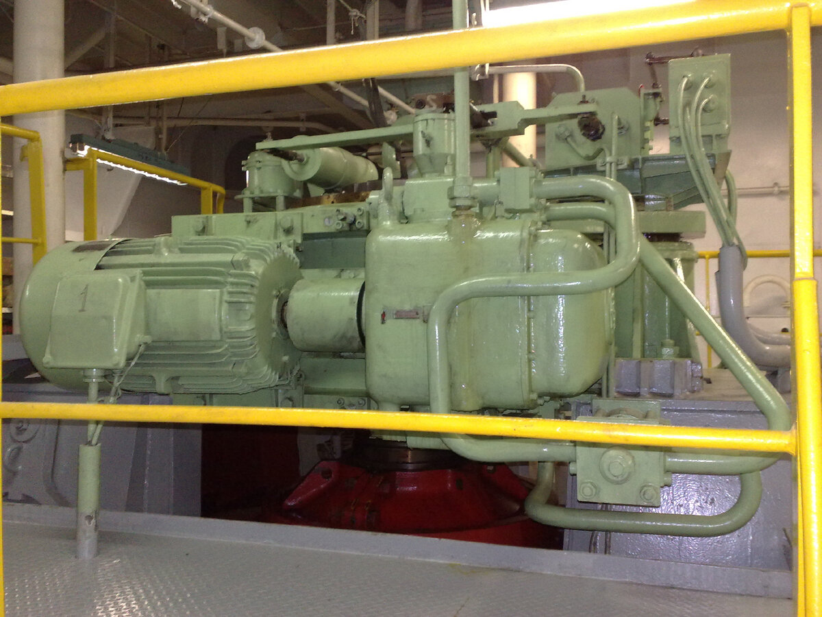 Электрический двигатель (на фото слева), предназначенный для работы Электрогидравлической рулевой машины на теплоходе. Фото автора.