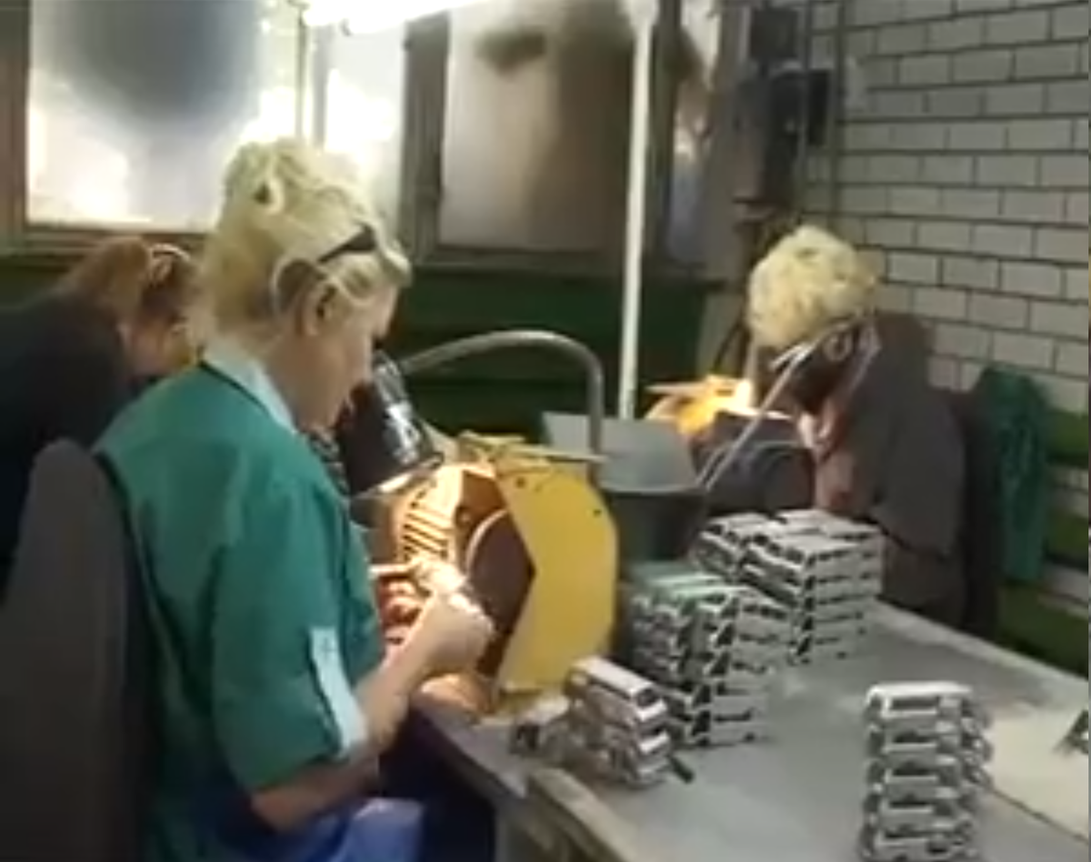 Обработку проходят кузова моделей Рафов. Мне больше всего интересно - чем таким занимается дальняя женщина в маске. Видимо, чем-то вредным, но чем?