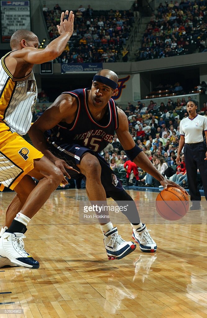 Vince Carter #15 of the New Jersey Nets is defended by Reggie Miller #31