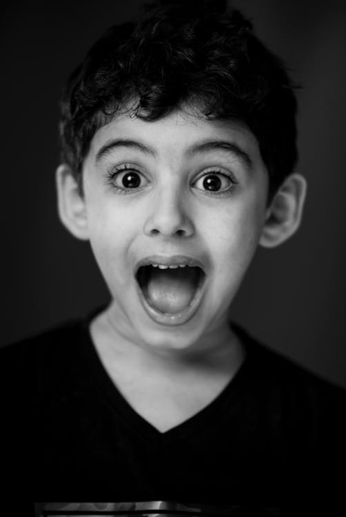 https://www.pexels.com/photo/boy-in-black-v-neck-shirt-with-looking-straight-to-the-camera-with-a-shocking-face-expression-76434