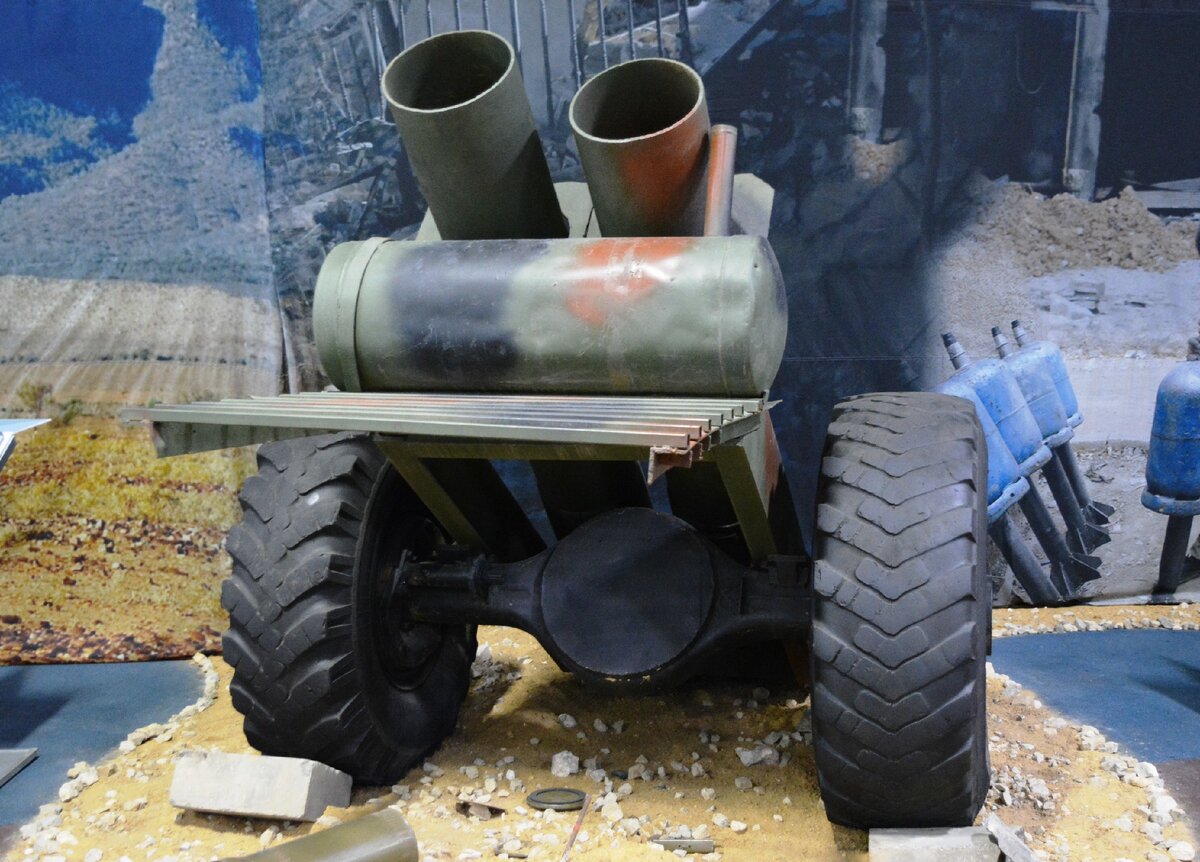 305 мм спаренный миномет кустарного производства. Буксируемое гладкоствольное орудие с двумя стволами. Отличается возможностью вести стрельбу по очереди с минимальными интервалами времени, что позволяет увеличить интенсивность артиллерийского огня.