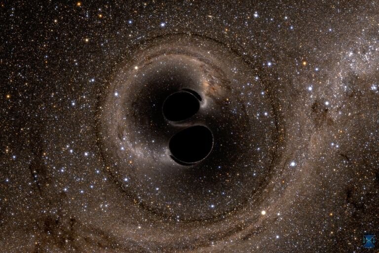 Это компьютерное моделирование показывает слияние двух черных дыр, которое произвело сигнал гравитационной волны GW150914.