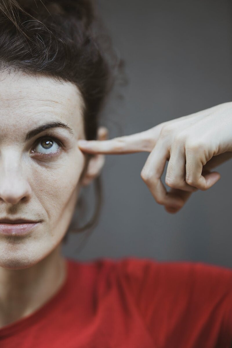https://www.pexels.com/photo/selective-focus-portrait-photo-of-woman-in-red-t-shirt-pointing-to-her-head-3148937/