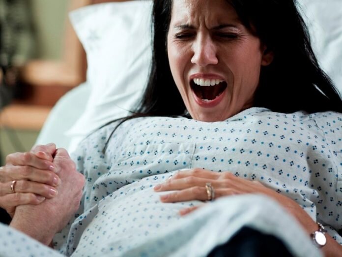 USA, Utah, Payson, Man assisting childbirth in hospital