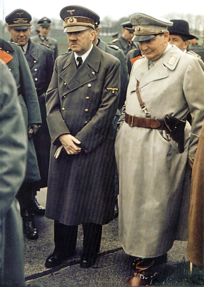 Color photo of the Second World War: Reichschancellor of the Third Reich Adolf Hitler and Minister of Aviation Hermann Goering surrounded by Wehrmacht officers.
