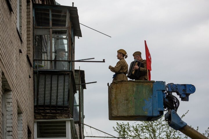 Покосившийся балкон, проржавевшая вышка, баянист и певичка, вот только не видно улыбки на лице ветерана...