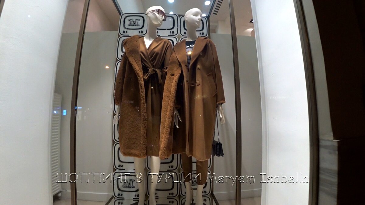 Манекен слева. Шуба стоит 20695 турецких лир, 202253 рубля. Платье 5859 лиры, 57260 рублей. Очки 3385 лиры, 33081 рубль. Манекен справа. Пальто 22595 лир, 220821 рубль. Футболка 2125 лиры, 20767 рублей. Брюки 3299 лир, 32241 рубль. Сумка 8195 лиры, 80090 рублей.