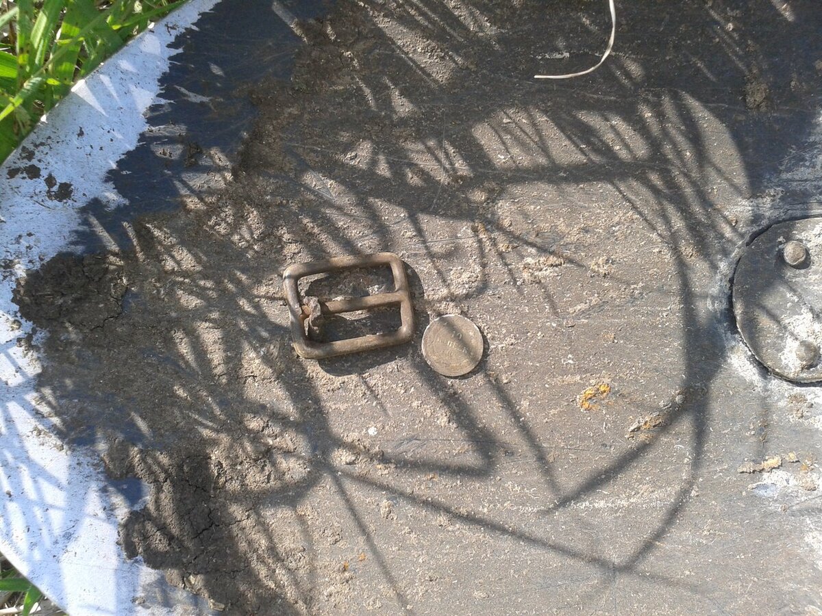 Пряжка и серебряная монета 1922 года.