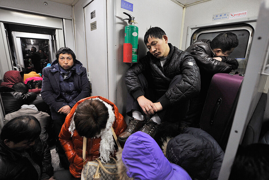 Пассажиры поезда, следующего из города Нинбо в город Чэнду, спят стоя и на чемоданах