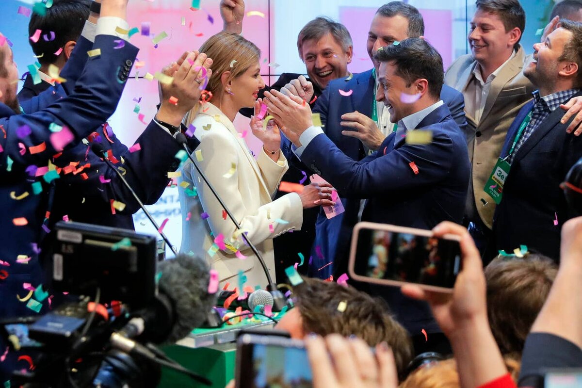 Volodymyr Zelenskiy, centre right, and his wife Olena Zelenska, greet supporters after exit polling gave the comedian a commanding lead. AP