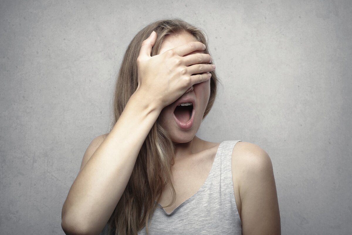 https://www.pexels.com/photo/woman-in-gray-tank-top-covering-her-face-with-her-hand-3812752/