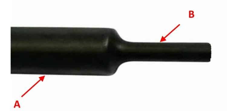 На рисунке показан кембрик, одна часть которого подверглась термообработке (В), вторая, не подвергшаяся нагреву, сохранила изначальный диаметр (А).