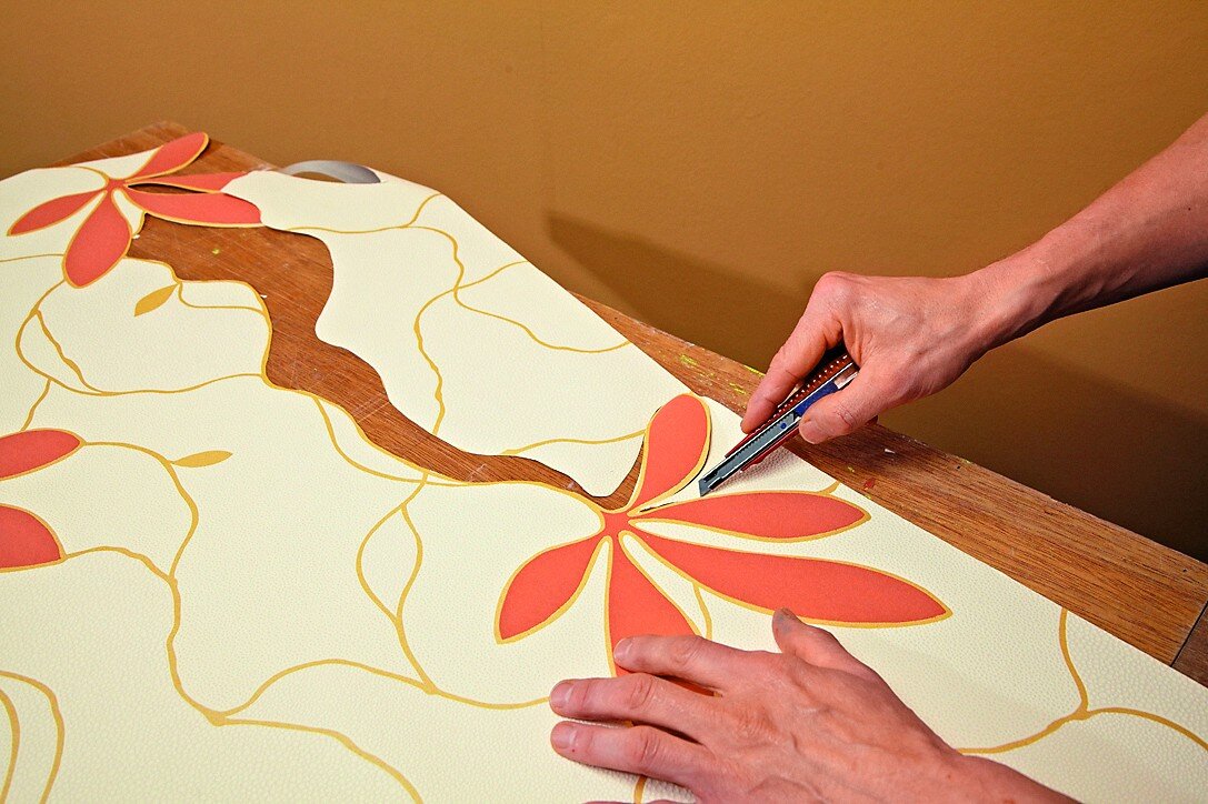 Понадобится обойный или канцелярский нож. Ножницами работать сложнее, а из-за оставленных ими неровностей и зазубрин результат будет выглядеть "дешево"