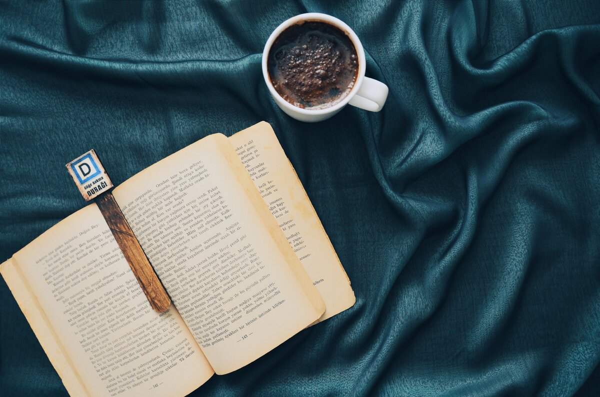 https://www.pexels.com/photo/white-ceramic-mug-filled-with-dark-brown-beverage-beside-opened-book-2305103/