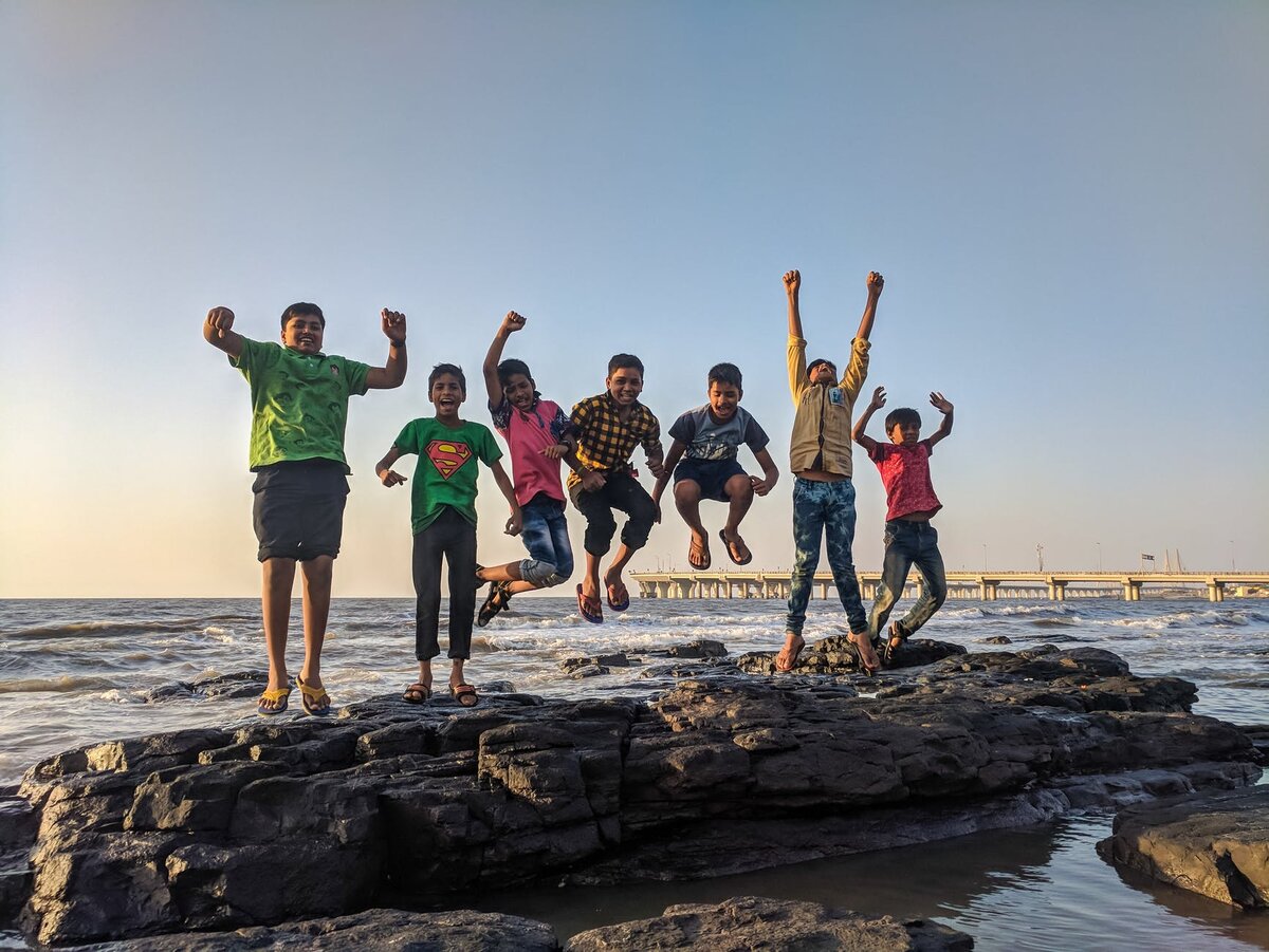 https://www.pexels.com/photo/boy-wearing-green-crew-neck-shirt-jumping-from-black-stone-on-seashore-939702/