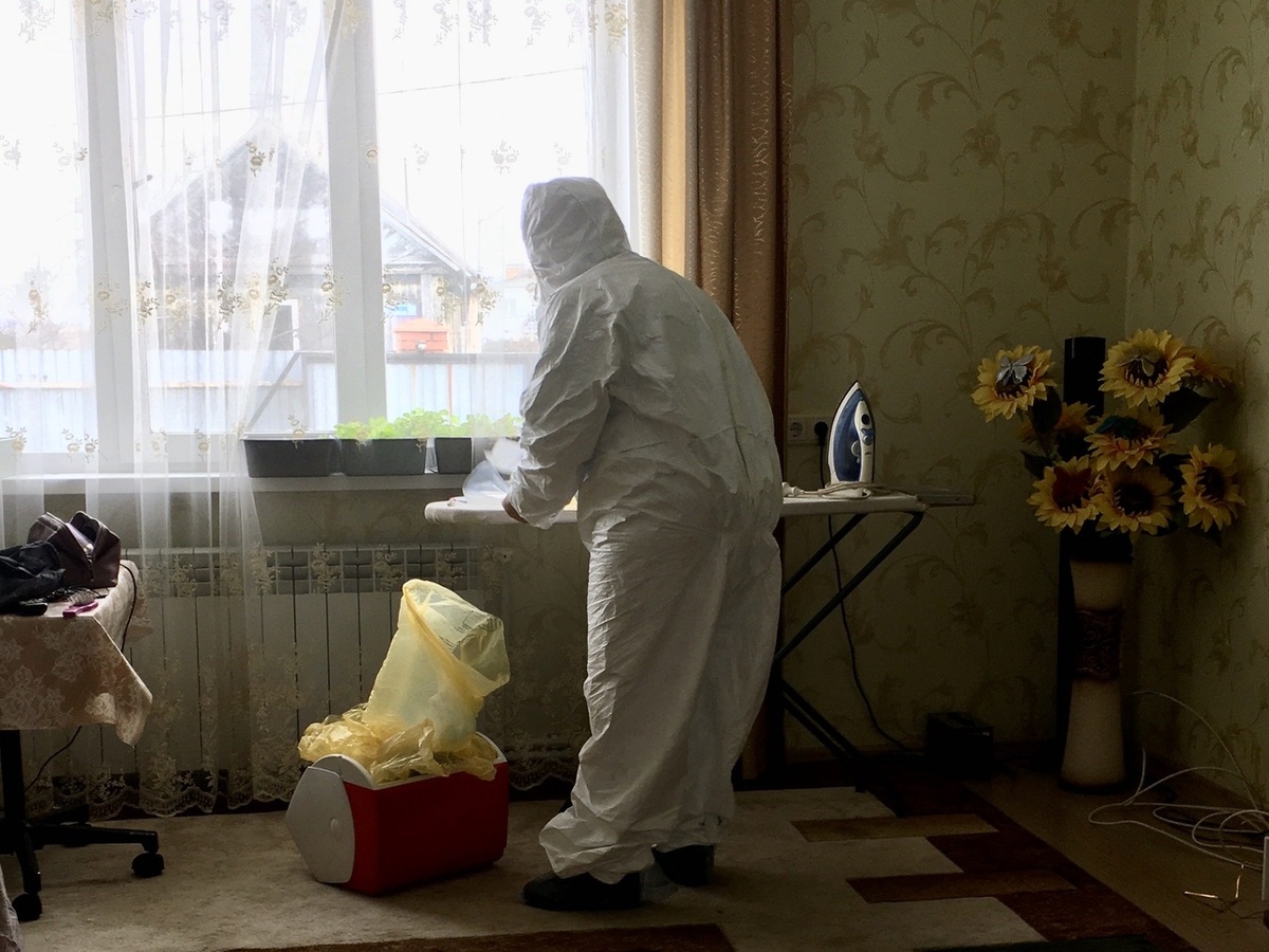 Распаковывает фартук, затем пакет с тестом