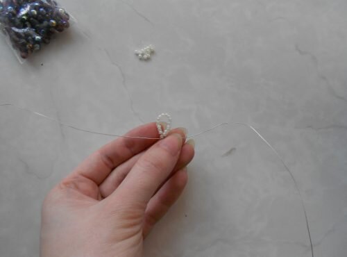 Сначала нанижите на проволоку десять-пятнадцать бисеринок (зависит от размера бусин), соберите в кольцо и скрепите дополнительной бисеринкой, в которою проденьте оба конца проволоки. Получится одна часть замочка для браслета. Количество бисеринок в нем путем пробы можно уменьшить или добавить — в колечко из бисера должна легко проходить бусина, при этом не выскакивая из него.