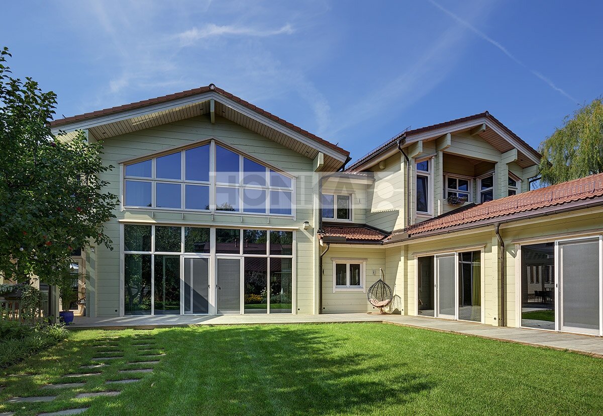 Выход из деревянного дома в уютное патио и сад