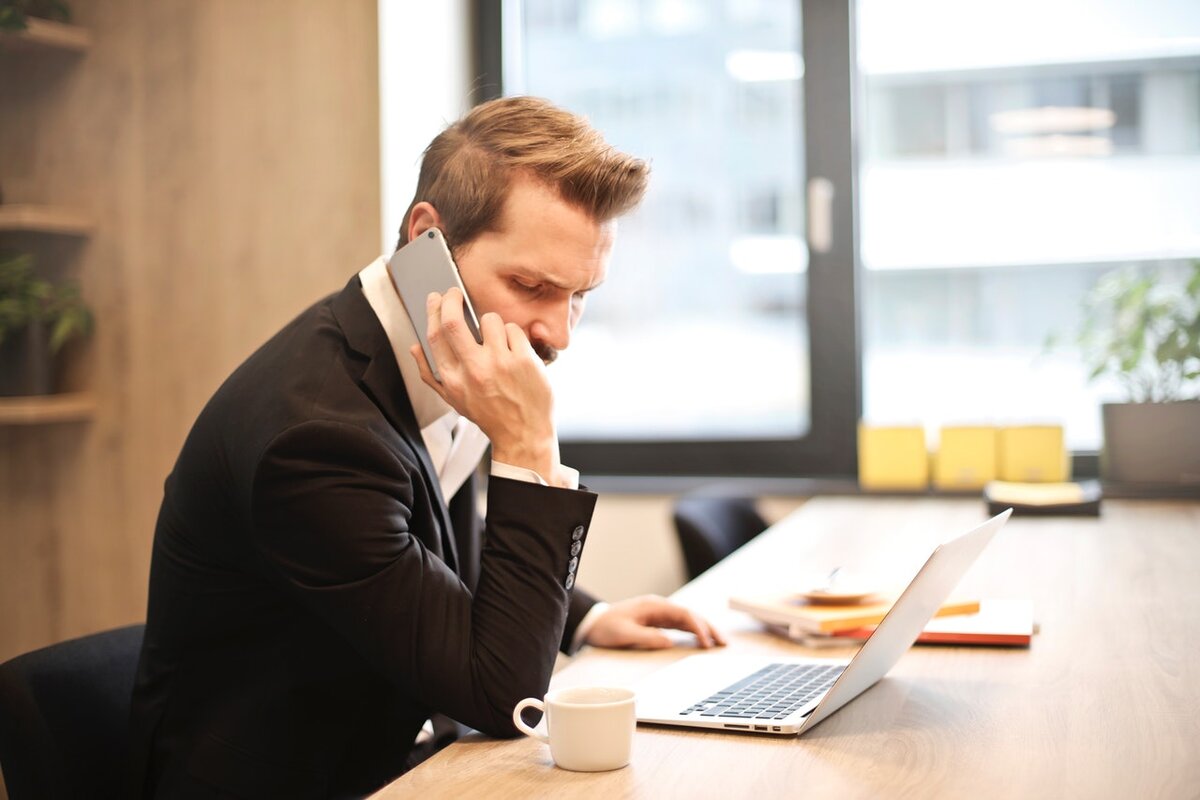 Source: https://www.pexels.com/photo/man-having-a-phone-call-in-front-of-a-laptop-859264/