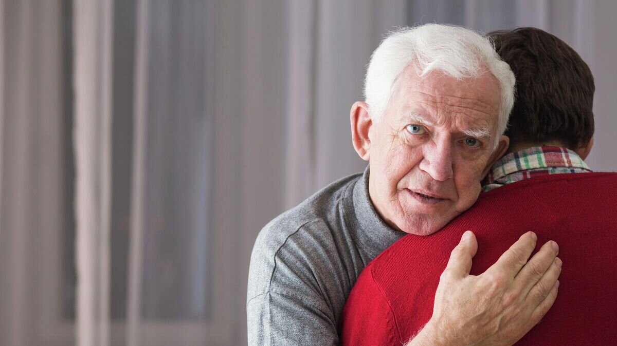    Пожилой мужчина обнимает сына© Depositphotos.com / photographee.eu