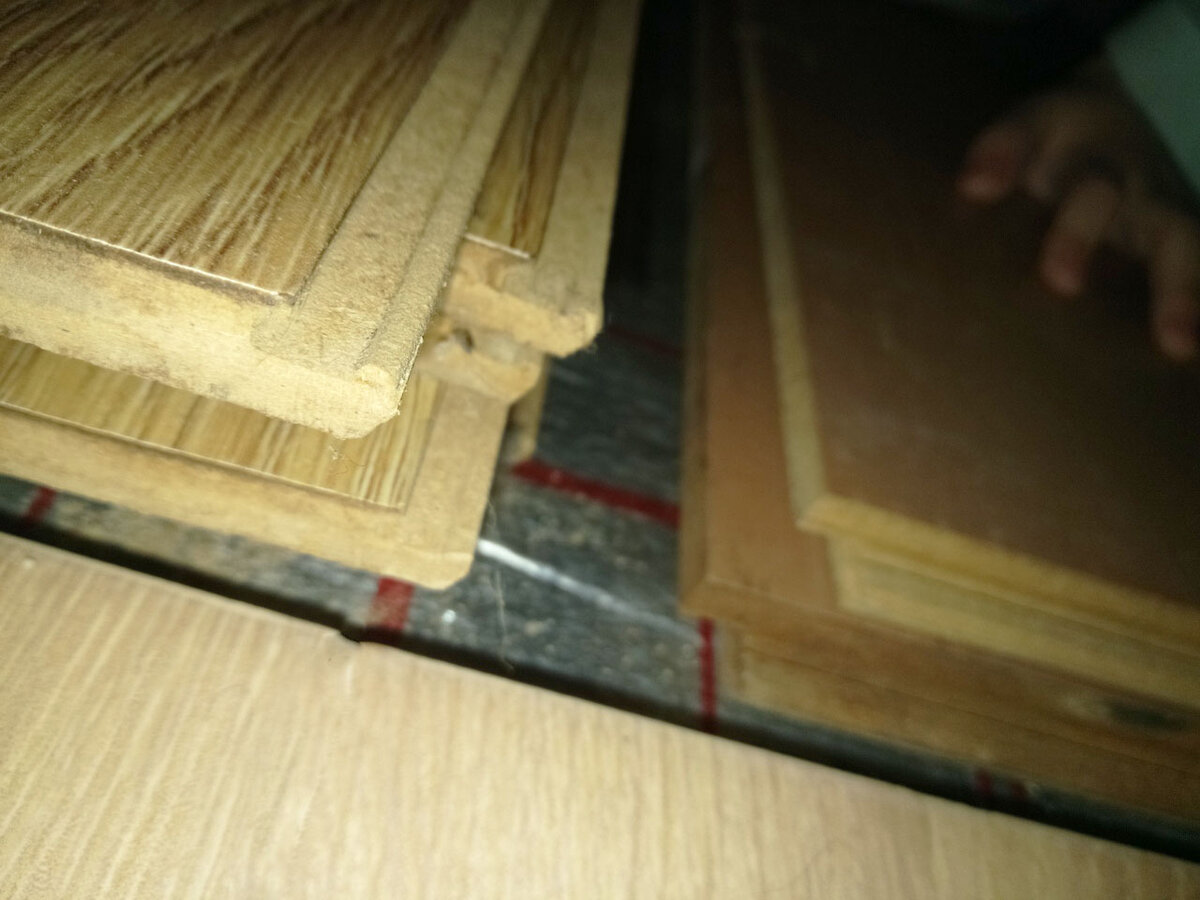 А тут на фото стык плитки и ламината, оба покрытия отапливаются, и детская рука вдали:) Запечатлён процесс разбора.