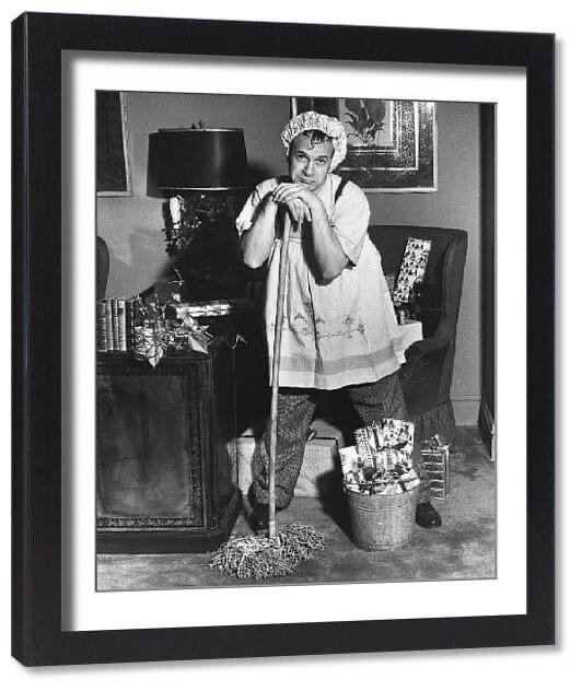 USA-CIRCA 1950s: Man dressed as cleaning woman in office