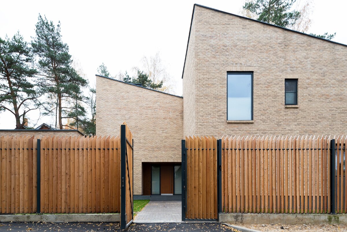 Фото входа с улицы - индивидуально спроектированный забор с поворотом досок ограждения для сохранения интимности жизни на участке