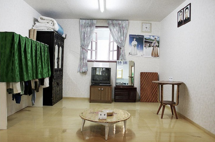 Северная Корея, на стене висят портреты вождей. Но очень мило и чистенько