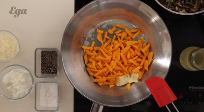 2. В глубоком сотейнике растопить сливочное масло и обжарить на нем мелко нарезанную мякоть тыквы, посолить, поперчить и жарить еще пять минут, постоянно помешивая. Потом влить бульон, перемешать и варить еще десять минут, после ­чего добавить сметану, тертый пармезан (25 г), грибы с чесноком, перемешать, сделать огонь минимальным и варить еще десять минут, время от времени, помешивая.