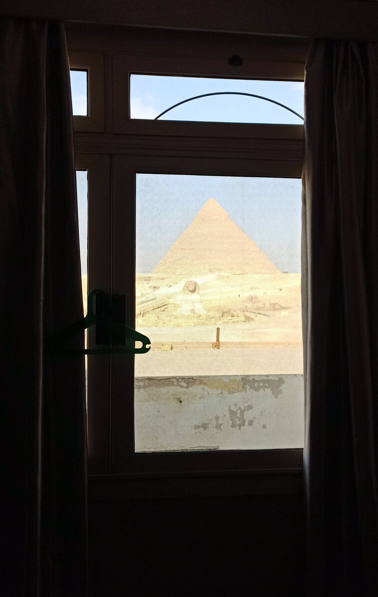 Вид на пирамиду Хафра и Сфинкса из окна номера отеля.