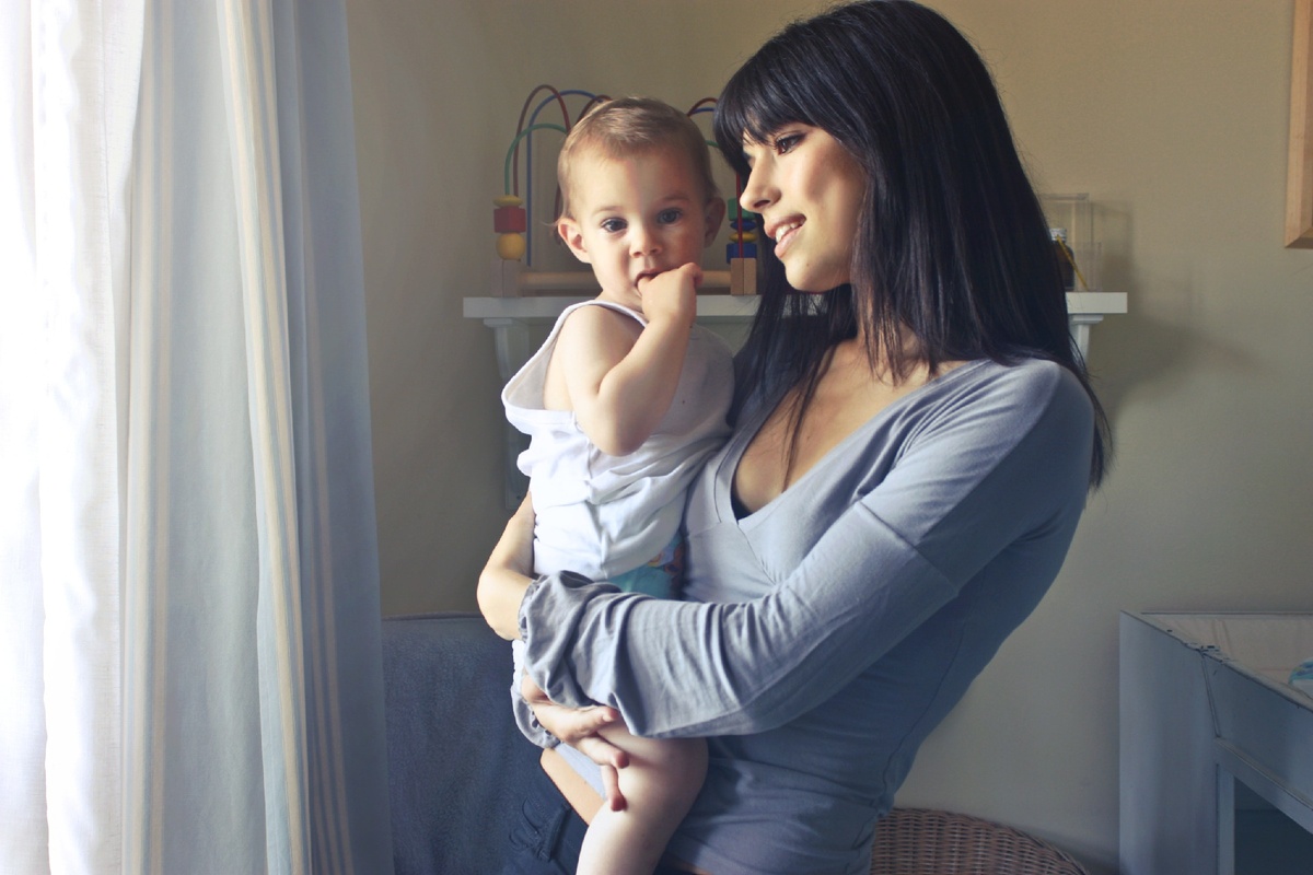 https://www.pexels.com/photo/woman-carrying-baby-boy-wearing-white-tank-top-infront-of-white-curtain-inside-the-room-755028/