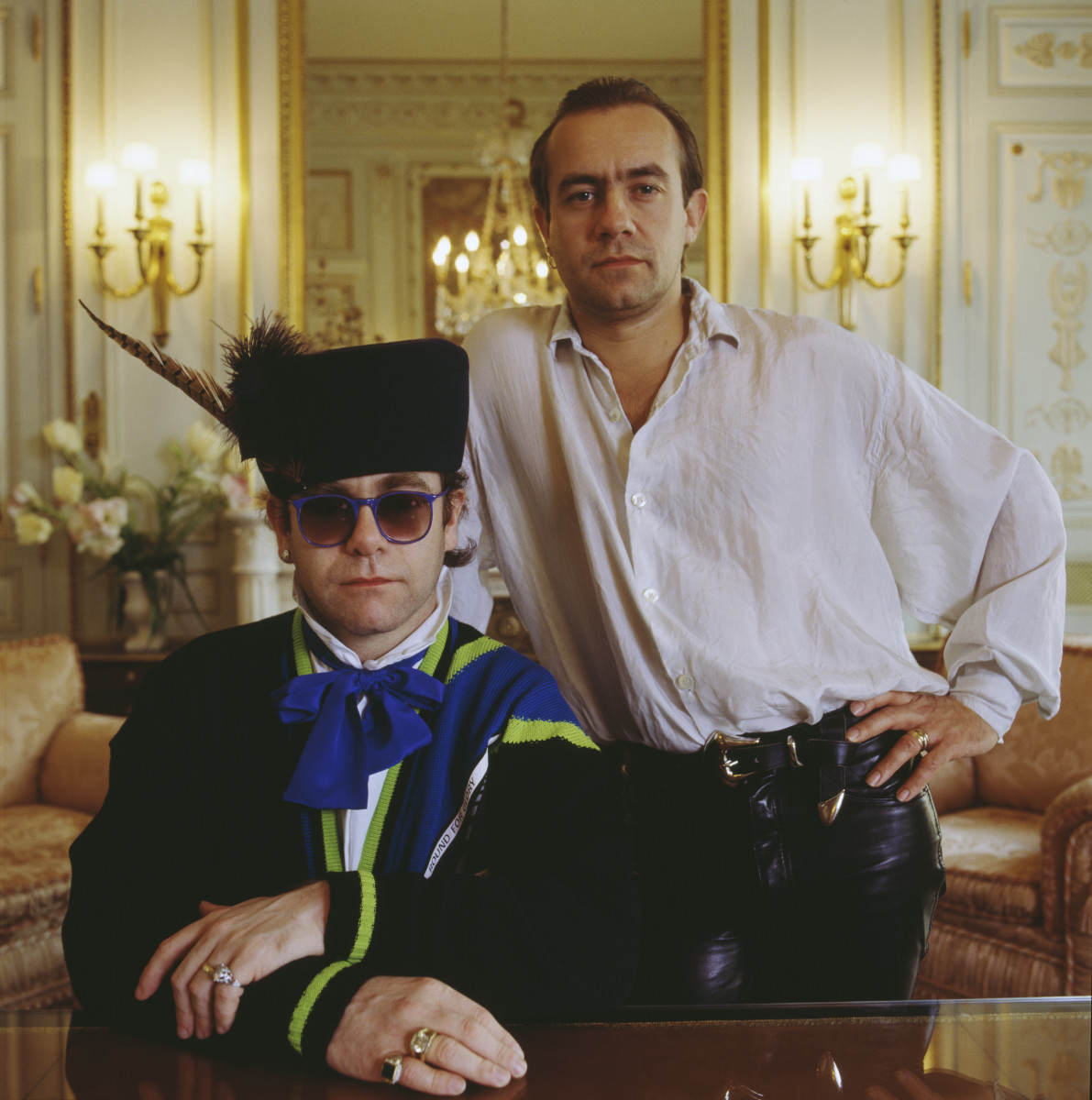 https;//www.biography.com/.image/t_share/MTYxMzIzNzIwMjYwOTg2MzU3/british-singer-elton-john-left-and-his-long-term-songwriting-partner-lyricist-bernie-taupin-1985-photo-by-terry-oneillgetty-images.j