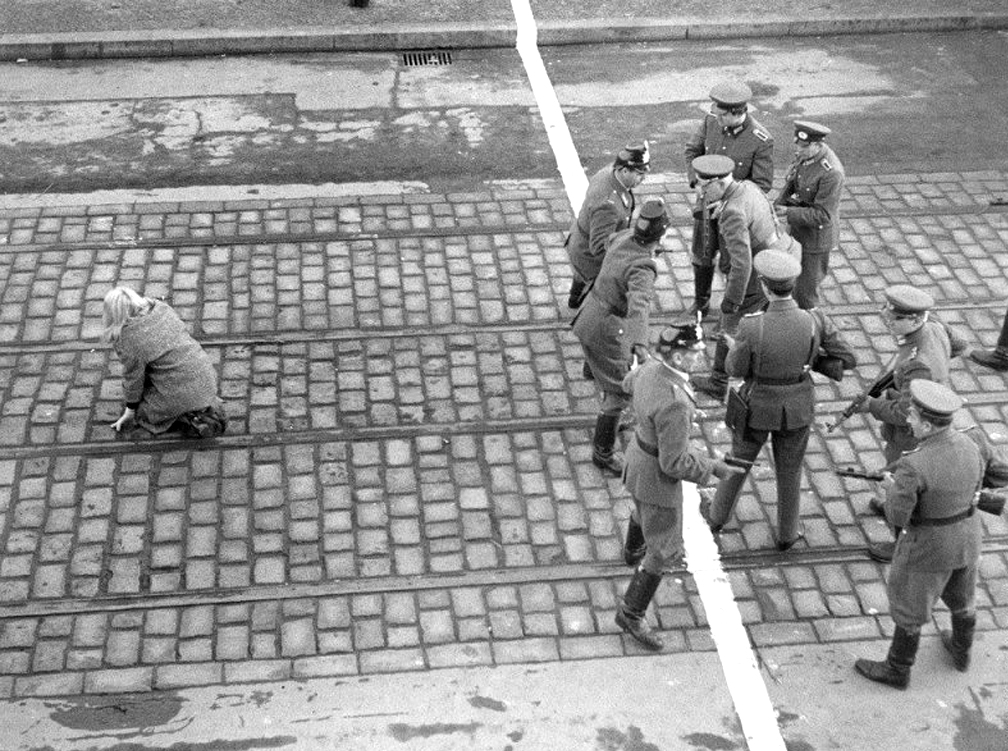 Пограничники ГДР и полицейские ФРГ спорят между собой из-за побега жительницы Восточного Берлина в Западный. Стены еще не было, граница определялась простой линией