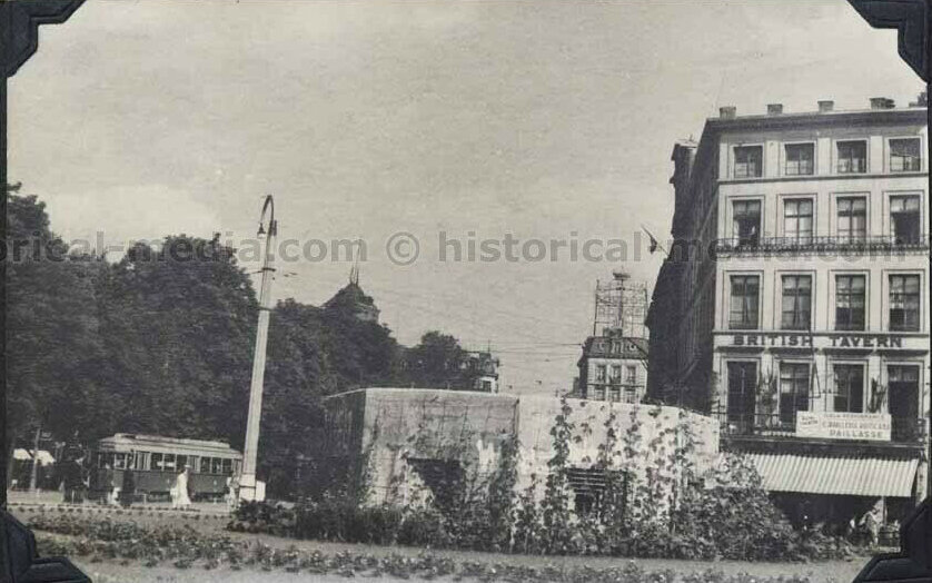 Фото датировано июнем 1945 г. Видимо так как война закончилась и потребность в лозунгах про войну отпала, городские власти быстро обсадили ДОТ цветочками и видимо плющем, чтобы скрыть серый бетон с глаз.  Фото с сайта https://www.ebay.com/