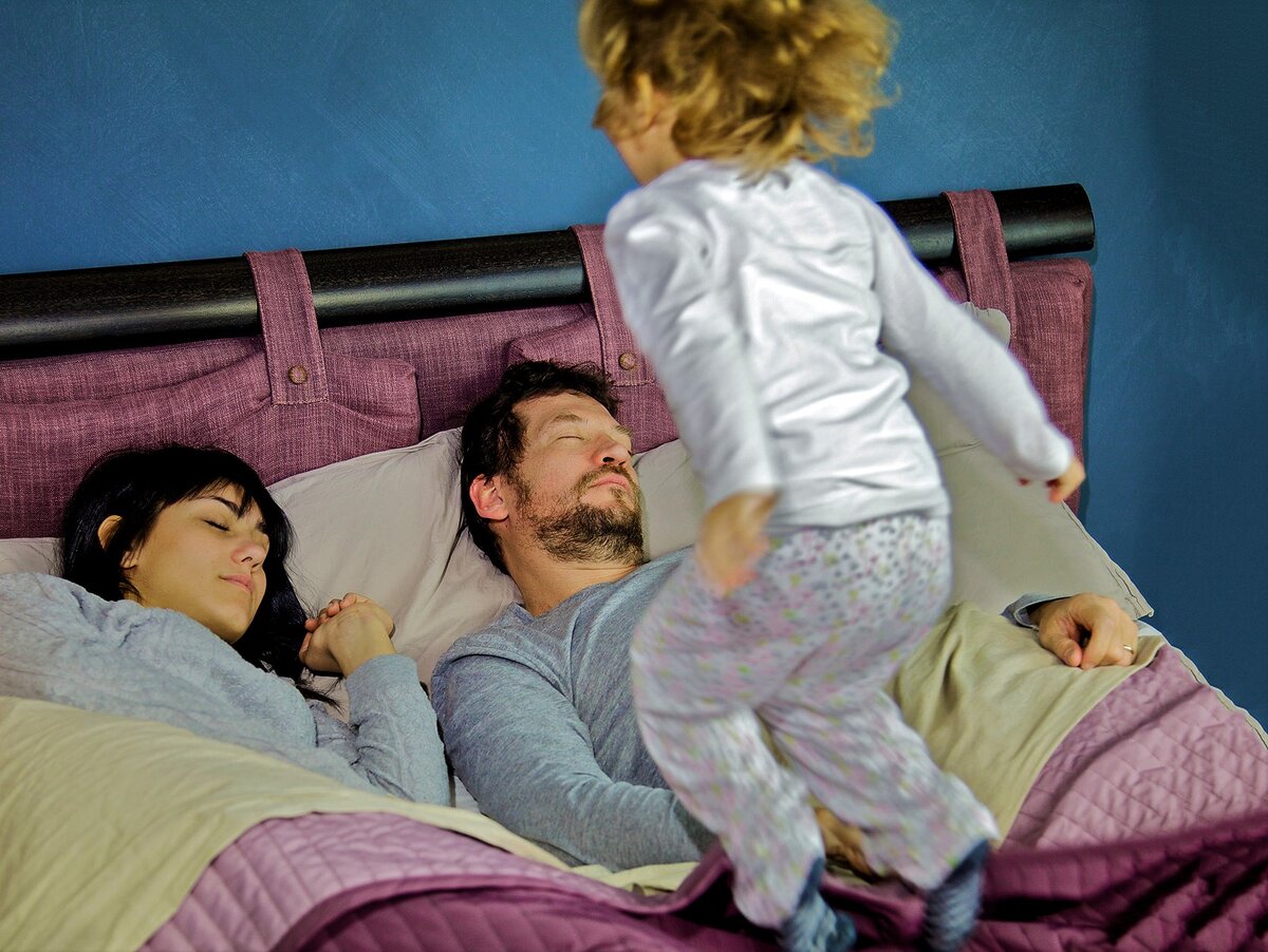 Ребенок в кровати с родителями