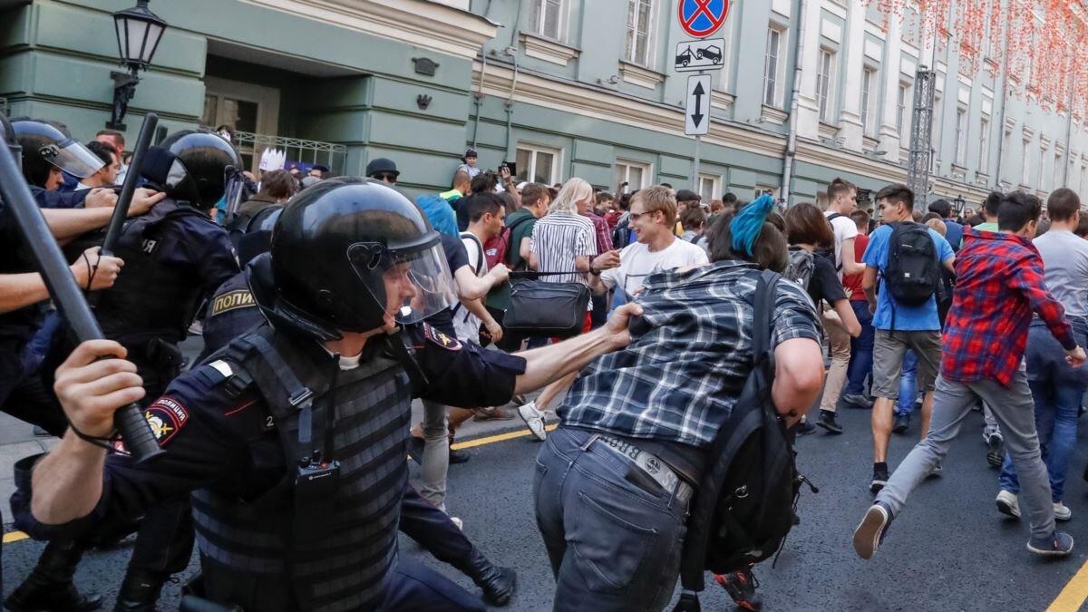 Полицейский пытается задержать гражданина. Картинка взята из источника: https://gdb.rferl.org/81F16482-1B42-4ED3-B718-684EE3459829_w1200_r1.jpg.