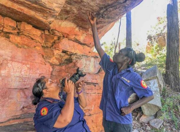Два члена сообщества Мималов фотографируют австралийские наскальные рисунки в районе реки Флиндерс в Австралии. (Mimal Land Management Aboriginal Corporation (MLMAC) / университет Флиндерса)