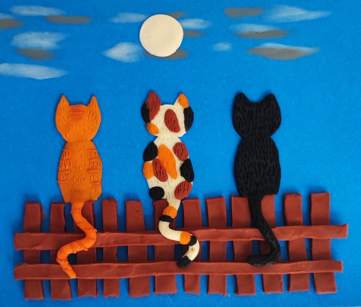 Готовый вариант аппликации из пластилина на цветном картоне " Котики смотрят на луну".